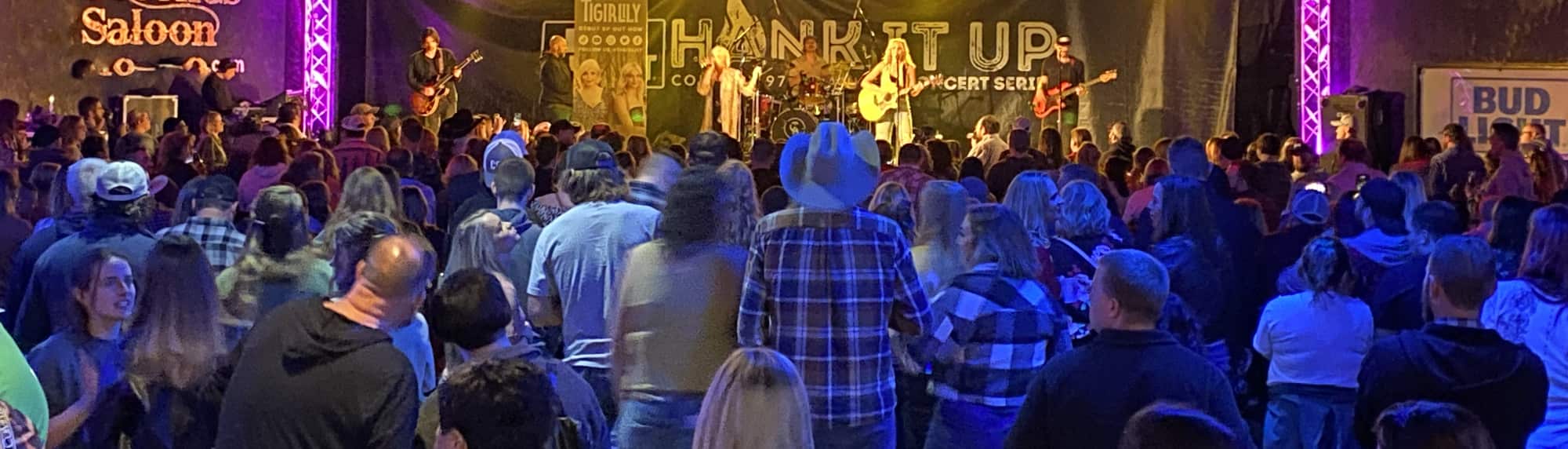 country concert with fans wearing cowboy hats Lexington