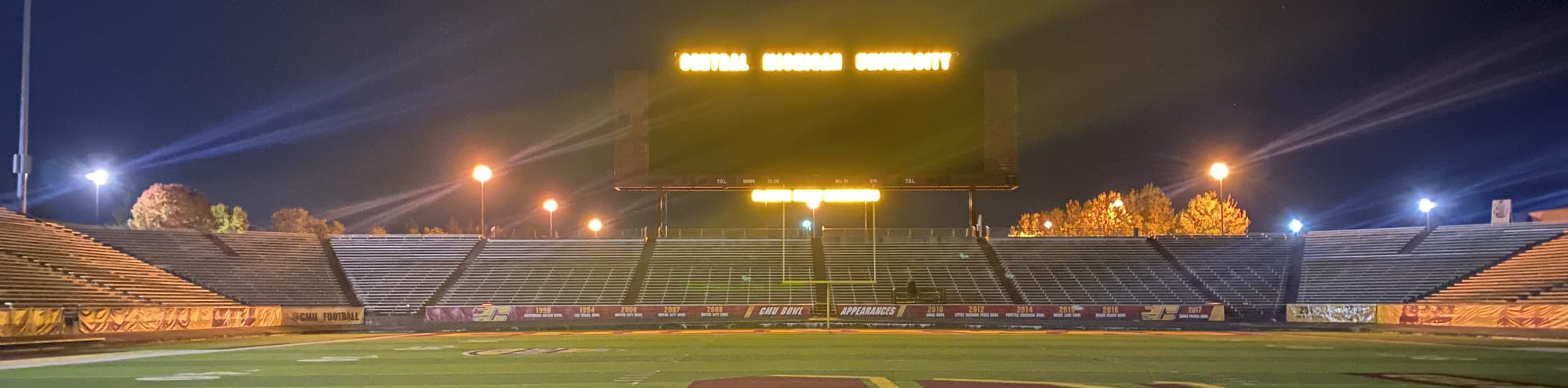 empty football stadium at night under the lights Lexington